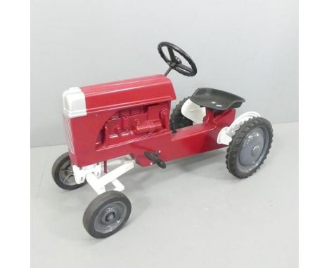 A Ford child's pedal tractor, moulded maker's mark reading "Scale models, Dyersville Iowa, made in USA", and with moulded sig