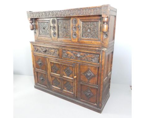 A 17th century oak court cupboard, with chip carved and panelled decoration. 156x165x54cm.Note inside one door reading:"The l