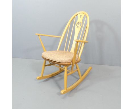 ERCOL - An EC62 rocking chair, with swan detail to back and original maker's gold button. Good condition.