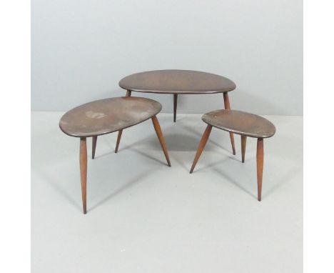 ERCOL - A nest of three pebble occasional tables, with blue maker's label. Largest 66x40x44cm. The middle table has some wate