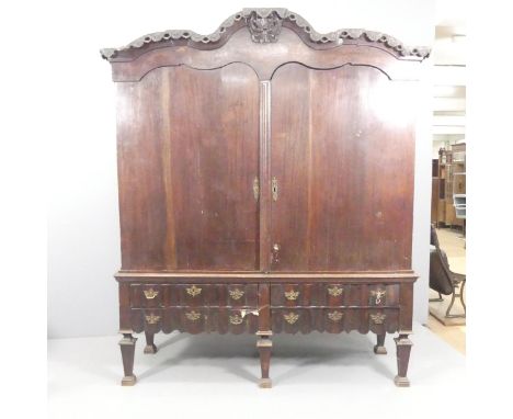 A 19th century continental oak and mahogany cabinet on stand, with panelled doors, shelf fitted interior, six drawers under, 