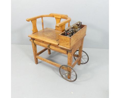 An early 20th century oak jockey scale on wheeled base. Overall 70x78x51cm. 