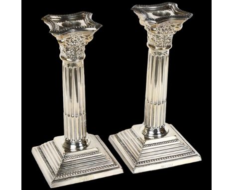 A pair of Elizabeth II silver Corinthian column candlesticks on stepped plinth base, H19cm, hallmarks for London 1964 