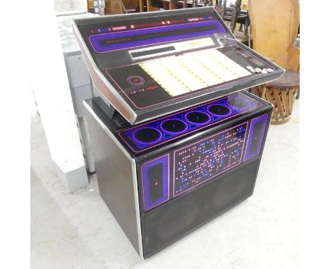 A Rock-Ola R453 Jukebox with vinyl records, circa 1970s. Working order. Key present. Comes with a selection of old 10p and 50