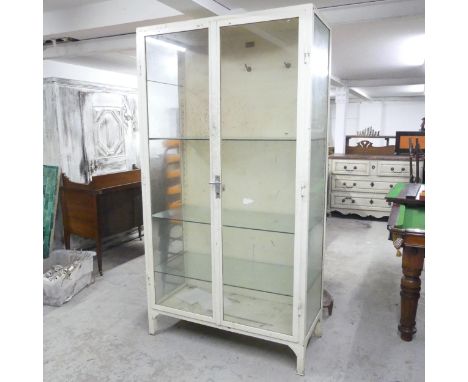 A vintage white painted enamelled metal medical cabinet, with three adjustable glass shelves. With label. 100x185x46cm.Good u