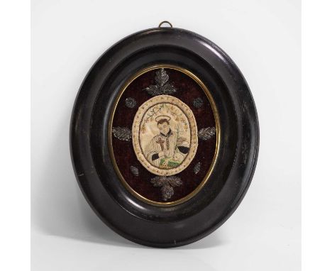 A memento mori framed needlework panel, 18th century, probably Italian, an oval religious needlework, embroidered with metal 