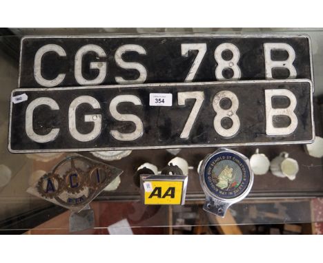 Vintage automobile badges together with vintage plates 
