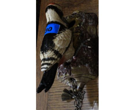 A metal woodpecker door knocker