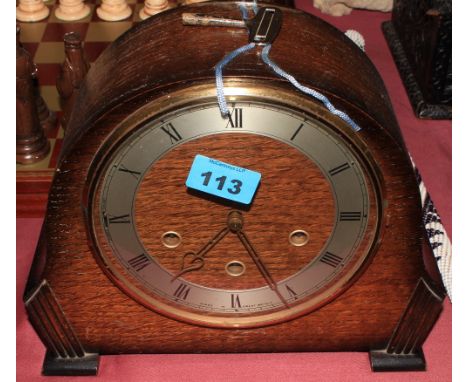 An oak case mantle clock