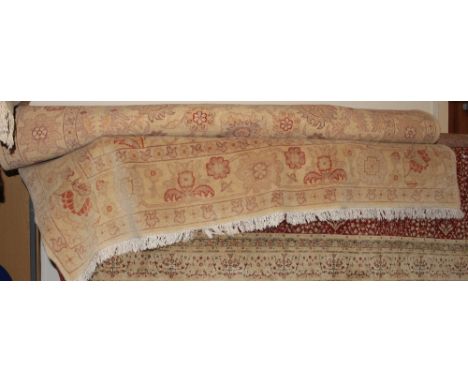 		A cream and terracotta wool carpet