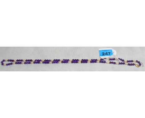 An amethyst and pearl bead necklace with clasp marked 375