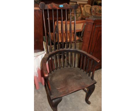 An antique comb back Windsor chair on cabriole legs
