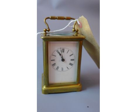 A brass carriage clock having Roman numerals to the dial (no key) H 15 x W 8 x D 7cm 