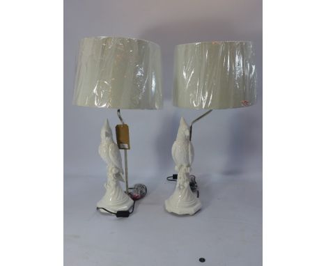 A pair of white painted plaster table lamps in the form of parrots. (with shades) H-45cm