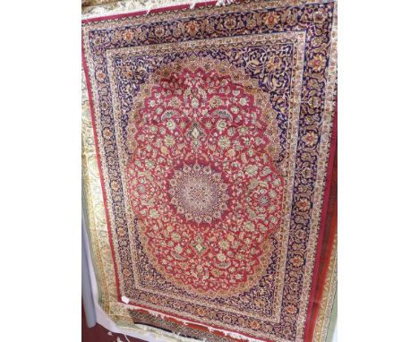 A Keshan style carpet having a red field, 230 x 160cm