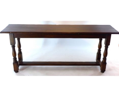 A 20th Century oak plank top table raised on turned legs and joined by stretcher. H 76 x W 182 x D 46cm 