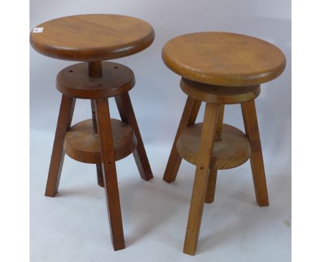 A pair of adjustable circular stools/sculptors tables raised on tripod supports