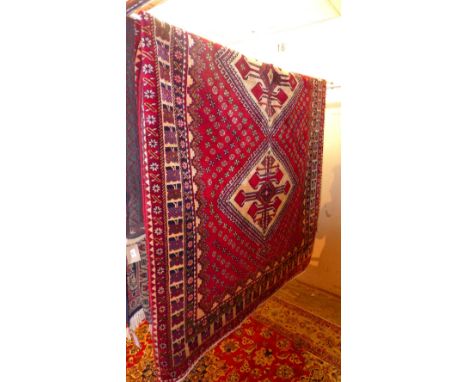 A fine South West Persian Abadeh carpet 310cm x 175cm triple diamond medallion with repeating petal motifs on a rouge field w