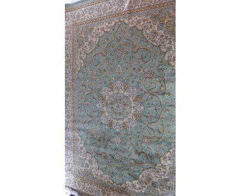 A Keshan style carpet having a green field, 280 x 200cm 