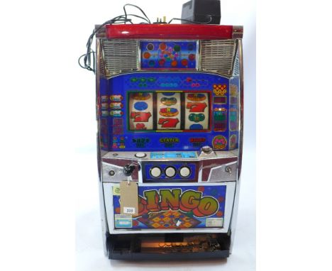 A 20th century table top fruit machine, with tokens, H 81 x W 48 x D 37cm 