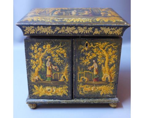 An Oriental 19th century lacquered table top work cabinet decorated with figures, having a lid opening to reveal a fitted int