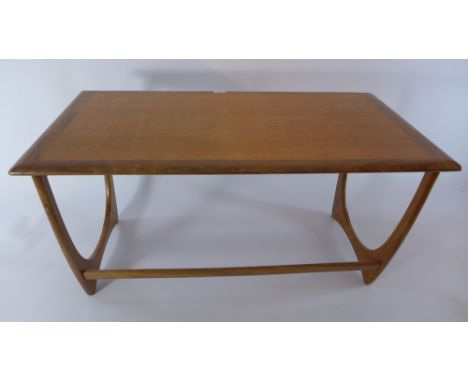 A C20th century teak coffee table.  H 52 x W 99 x D 50cm 