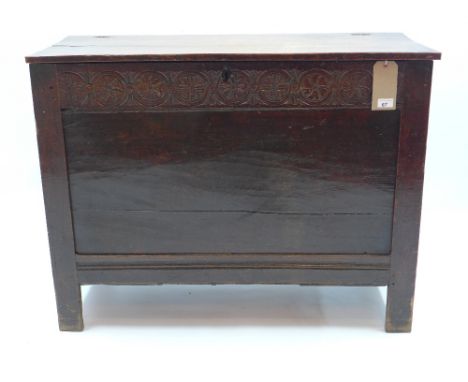 A 19th century oak coffer of panelled construction with one carved panel raised on square legs, H 79 x W 101 x D 44cm 