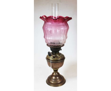 A Victorian brass oil lamp, with acid etched cranberry glass shade, h.51cmCondition report: Shade and chimney good.Some minor