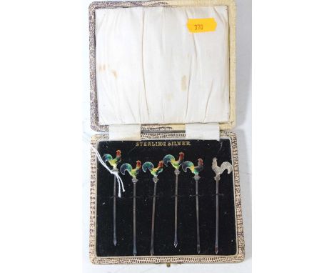 A set of six mid-20th century sterling silver cocktail sticks, each terminal enamel decorated in the form of a cockerel, in f