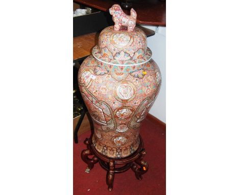 A large 20th century Chinese temple jar and cover, the lid with dog of fo and with floral enamel and gilt decoration, on a ha