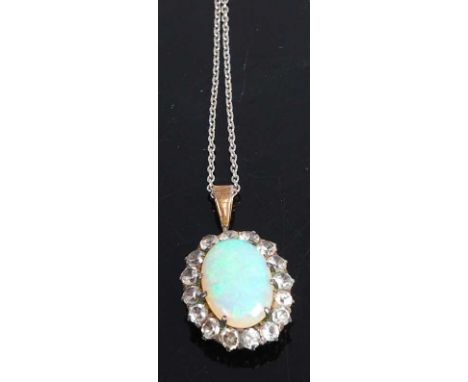 A yellow and white metal, opal and colourless sapphire oval cluster pendant, the opal cabochon measuring approx 16.6 x 10.9 x