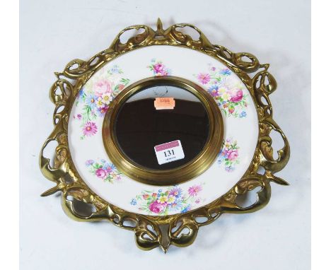 A brass and china wall mirror, with central convex plate, mounted on a ceramic plate by Royal Staffordshire to a design by Cl