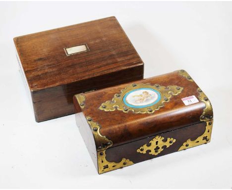 A Victorian walnut and brass mounted box, the hinged lid inset with an oval porcelain plaque decorated with a cherub holding 