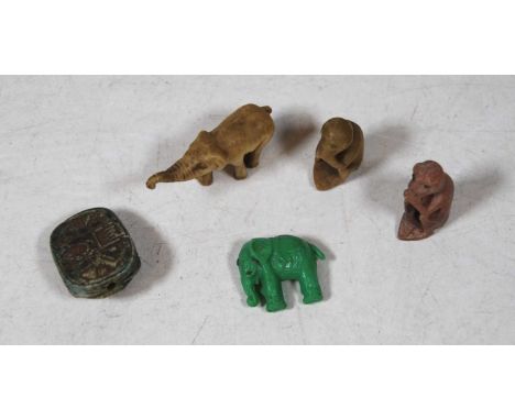 A small carved stone netsuke in the form of a beetle; together with four small carved stone animals, being two elephants and 