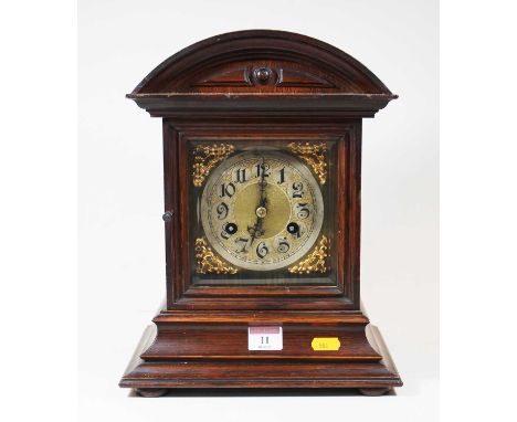 A late 19th century oak cased mantel clock, having eight day movement, the silvered chapter ring showing Arabic numerals, the