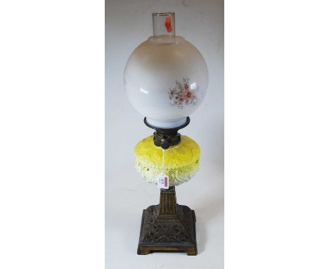 A late Victorian oil lamp, having an associated opalescent glass shade and yellow glass font, on a pierced iron base, h.63cmC