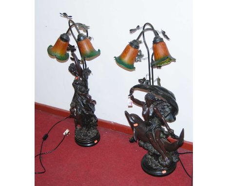 A large Art Nouveau style resin figural table lamp, in the form of a semi-nude maiden seated upon a  dolphin, all on rocky ba