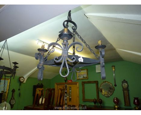 A wrought iron four branch Gothic style ceiling light with Fleurs de Lys pattern