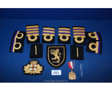 A Royal Navy captain rank shoulder board Epaulette and a BP Merchant Navy cap badge, medal and tie pin etc.