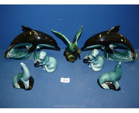 A quantity of Poole animals including two 1960's dolphins, a flying swan, two seals and two otters.