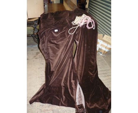 A pair of brown velvet Curtains with tie backs, 64'' wide x 80'' drop.