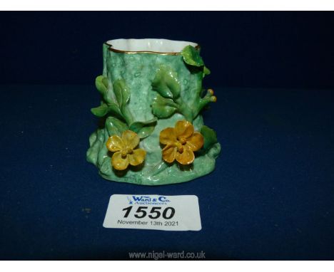 A Royal Worcester posy vase in the form of a tree stump with applied yellow buttercups, 2 1/2" tall, no. 3998.