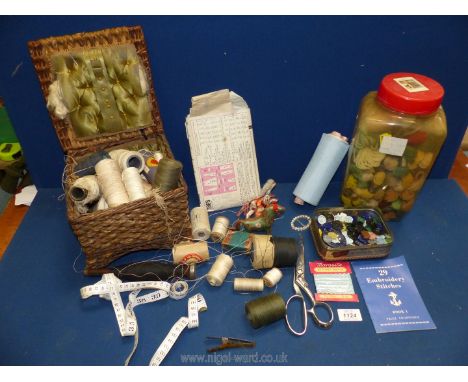 A silk lined wicker sewing basket, vintage threads, tapestry wool and a large collection of sewing items.