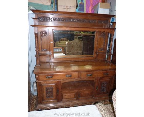 An early 20th c. Oak bevelled mirror back Sideboard having Art Nouveau design carved details, 74'' w x 82 1/2'' h x 23 1/2'' 