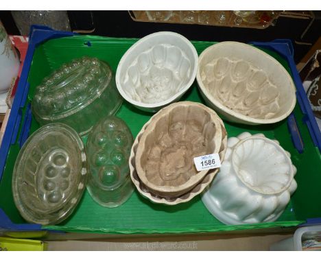 A quantity of ceramic and glass Jelly Moulds, some hairline cracks