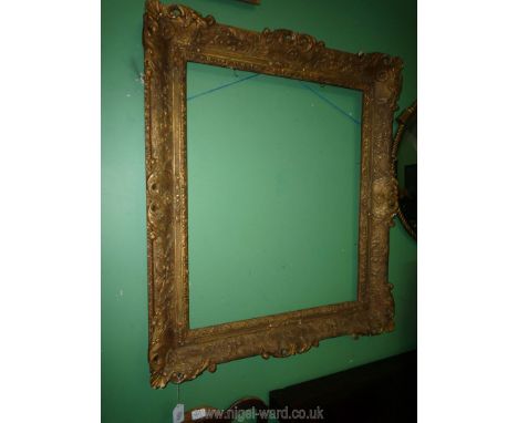 A gilded carved and gesso Picture Frame with scrollwork, floral and shell decoration, to suit an art work up to 30 1/2'' x 25
