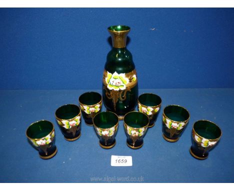 A green and gilt decanter (no stopper) set having eight shot glasses.