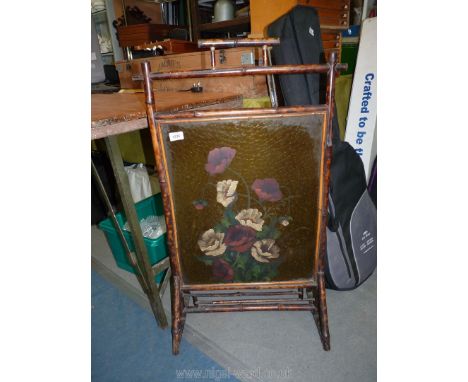 A glass and bamboo firescreen with painted flowers, handle a/f.