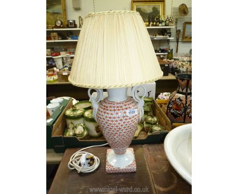 One orange patterned china lamp with shade.