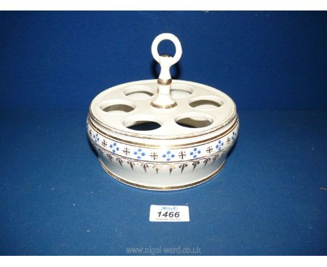 A  vintage circular ceramic egg holder with central handle.